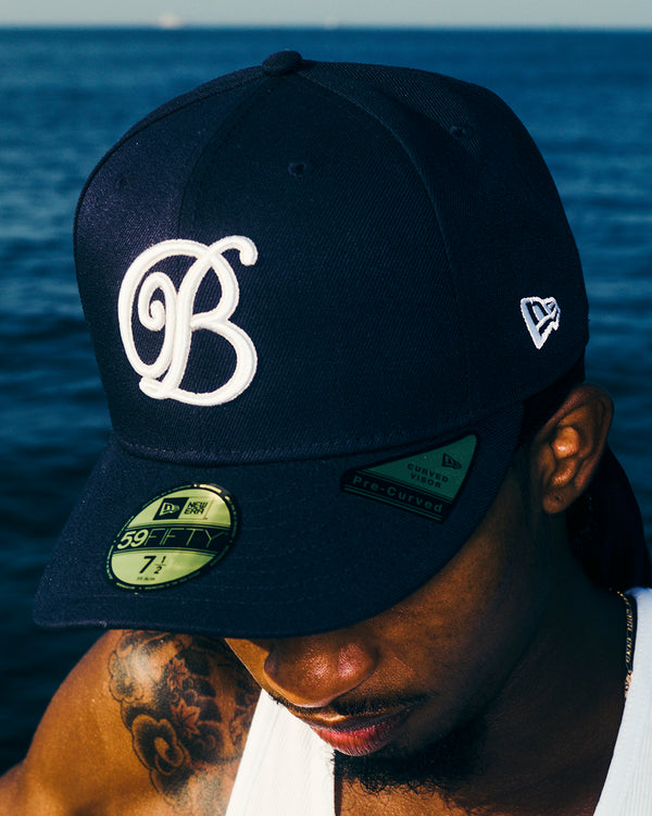 B EMBELEM PRE CURVED NEW ERA CAP NAVY