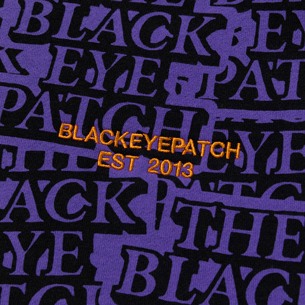 Purple Crew Sweatshirt Covered in Stickers